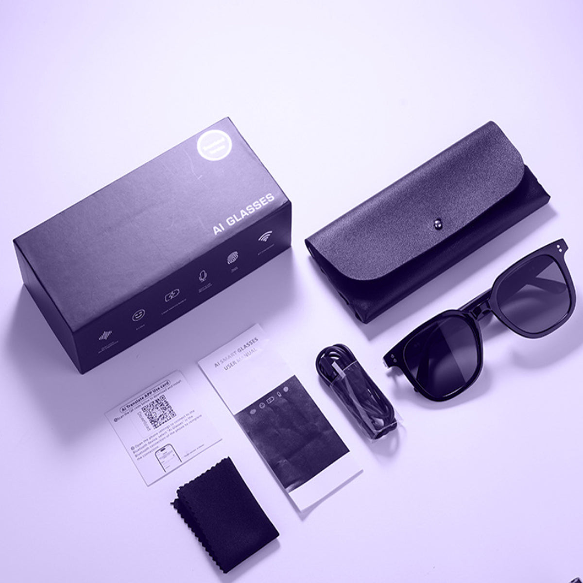 VocaLens AI Smart Sunglasses with photochromic lenses Set of sunglasses with accessories including a box, case, cleaning cloth, and user manual on a light purple background.