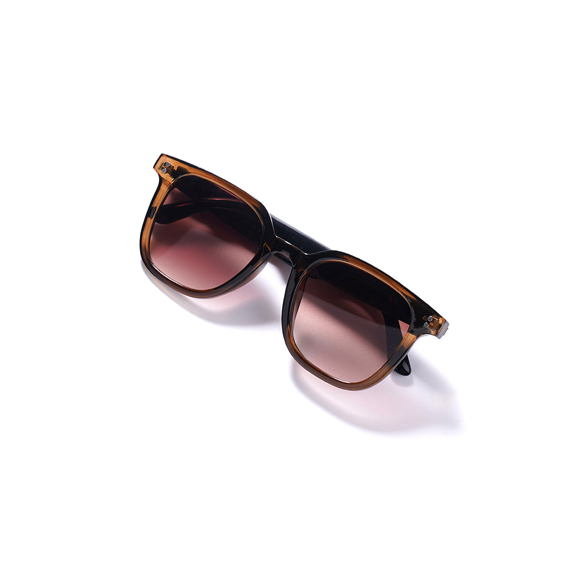 Sunglasses with brown frame and pinkish-brown lenses on a white background