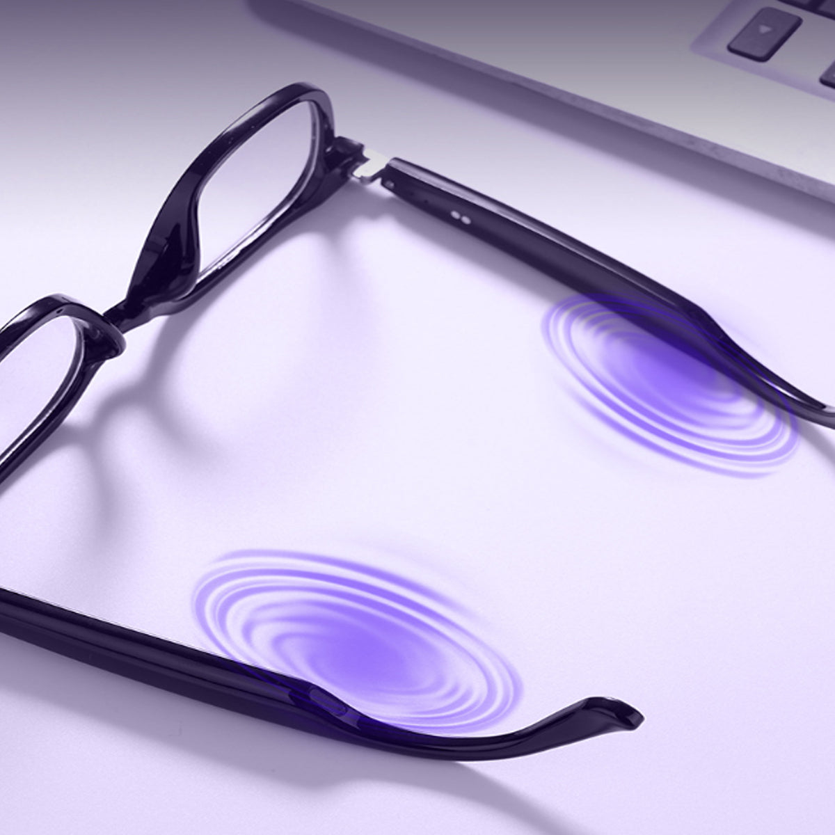 VocaLens AI Smart Sunglasses with clear photochromic lenses Black glasses with UV light emission on a white surface
