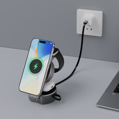 Smartphone on a wireless charging stand with a cable plugged into an outlet, on a gray surface.